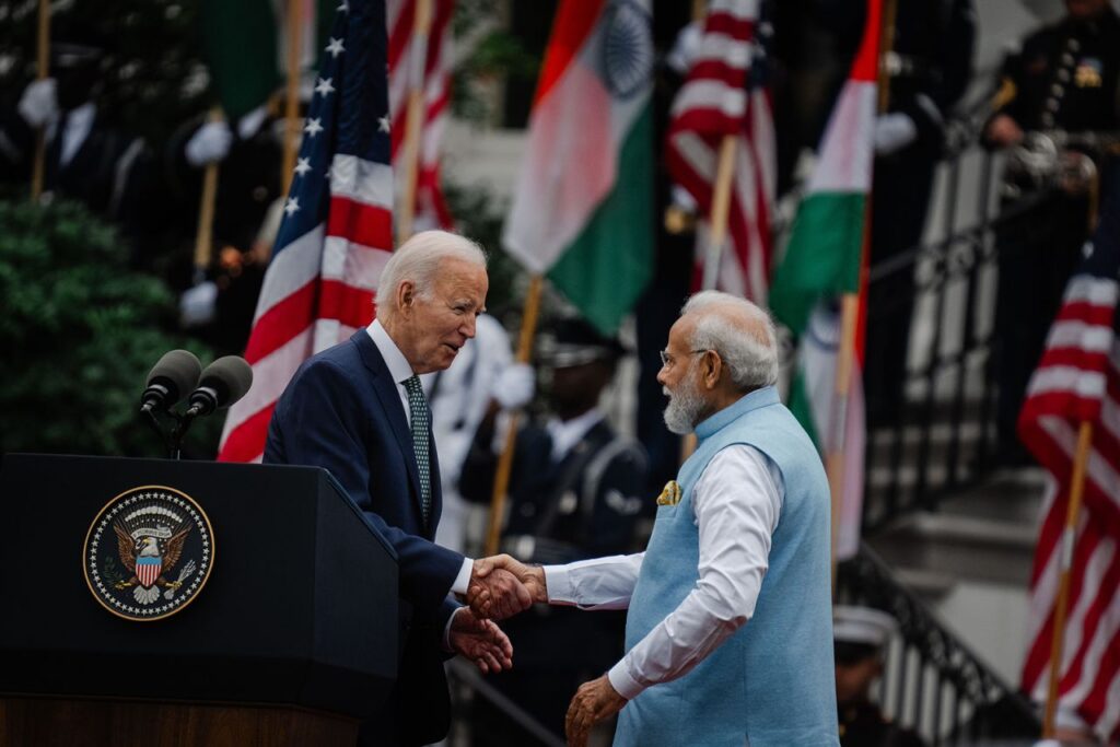 President Joe Biden and Indian Prime Minister Narendra Modi sit at a conference table during diplomatic talks.