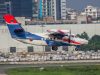 Pentagon Report Reveals Russian Jet at Iraq Base A military surveillance aircraft flies over a desert airbase with runway lights visible below.