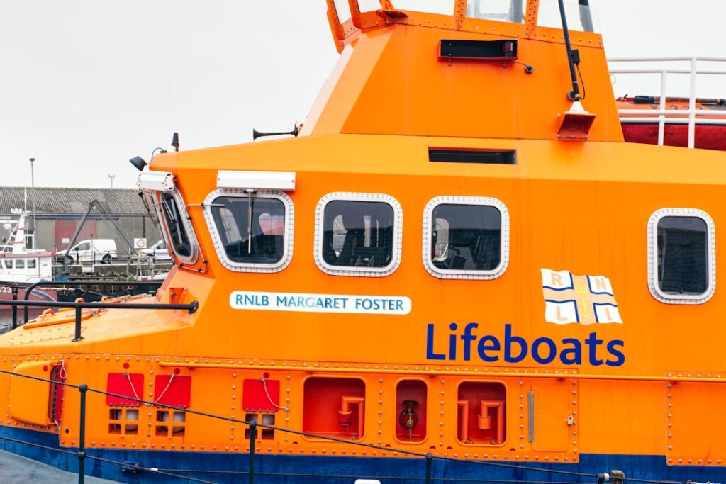 Rescue boats pull migrants from the cold English Channel waters near a coast guard vessel on a December day.