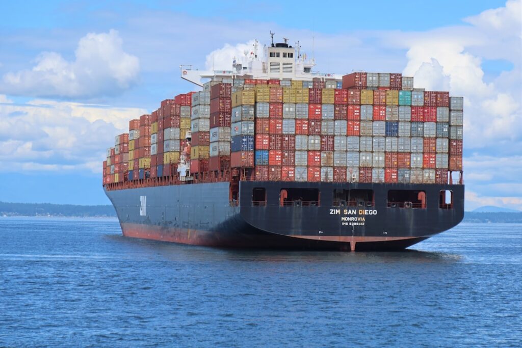 China Coast Guard cutter approaches a partially submerged cargo ship in the South China Sea during a rescue operation.