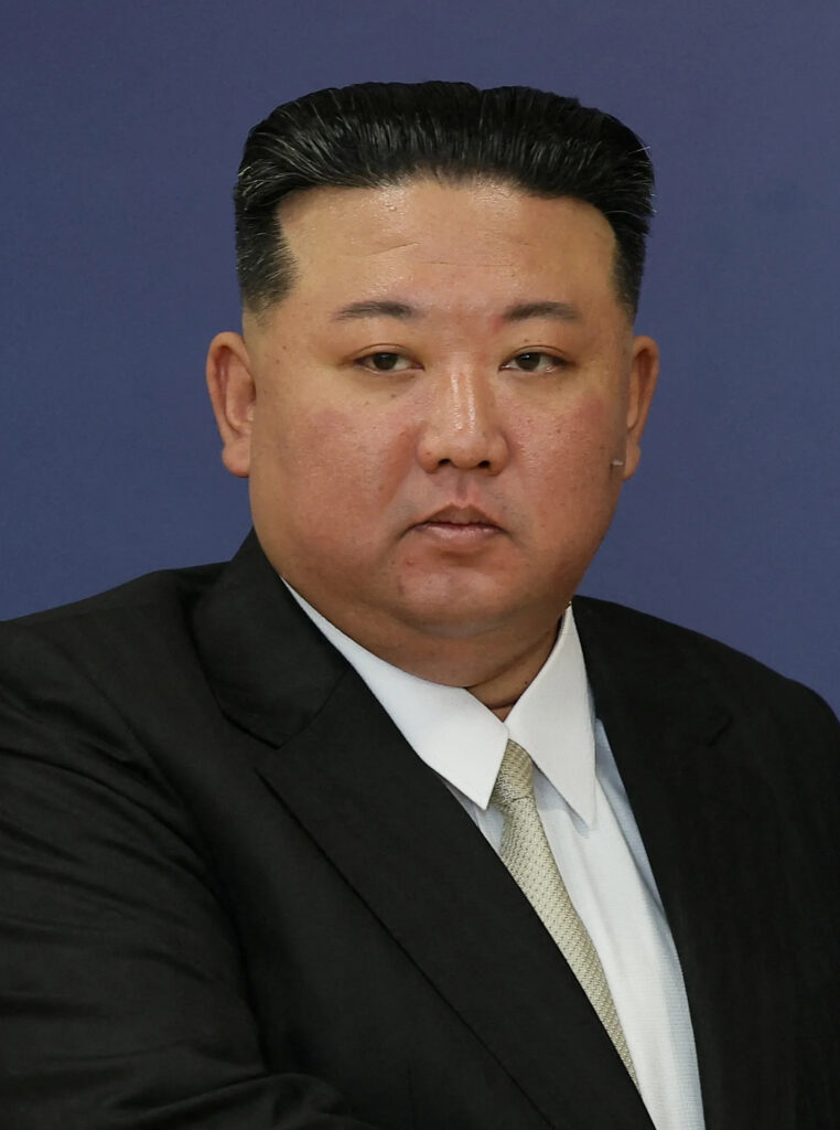 Kim Jong Un stands at a podium during a public address in North Korea
