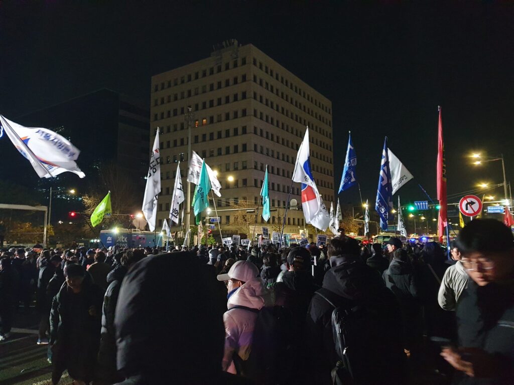 South Korean President Yoon Suk Yeol speaks on national TV announcing martial law as troops deploy outside the National Assembly building in Seoul.