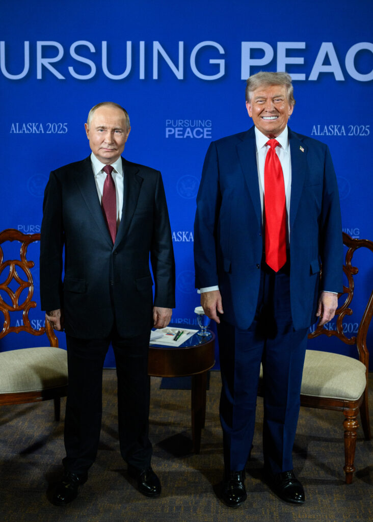 President Donald Trump and President Vladimir Putin seated at a conference table during the 2025 Russia–United States Summit in Alaska.