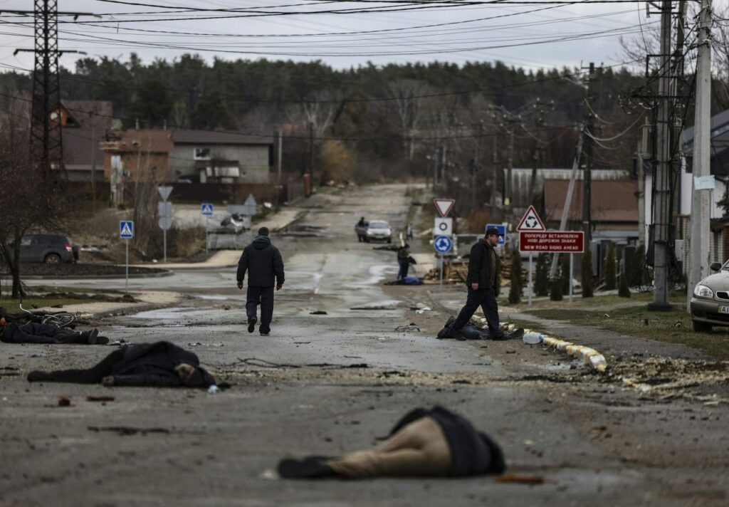 Black plastic-wrapped bodies lie in a street in Bucha, Ukraine, after Russian forces withdrew from the area northwest of Kyiv.