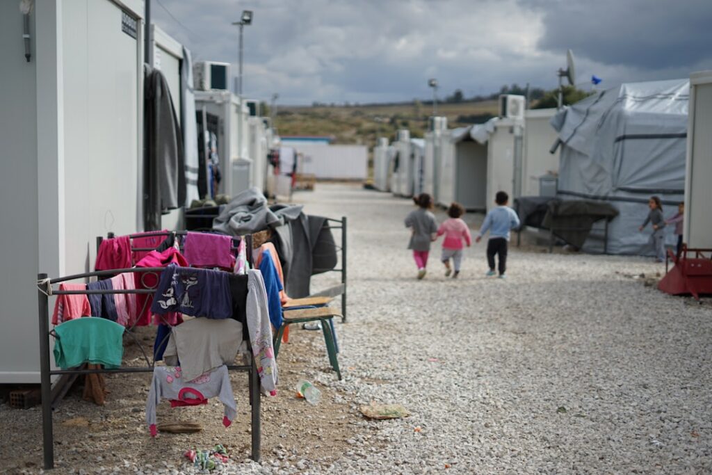 Families with suitcases walk along a crowded road toward the Polish border after Russian strikes hit western Ukraine.