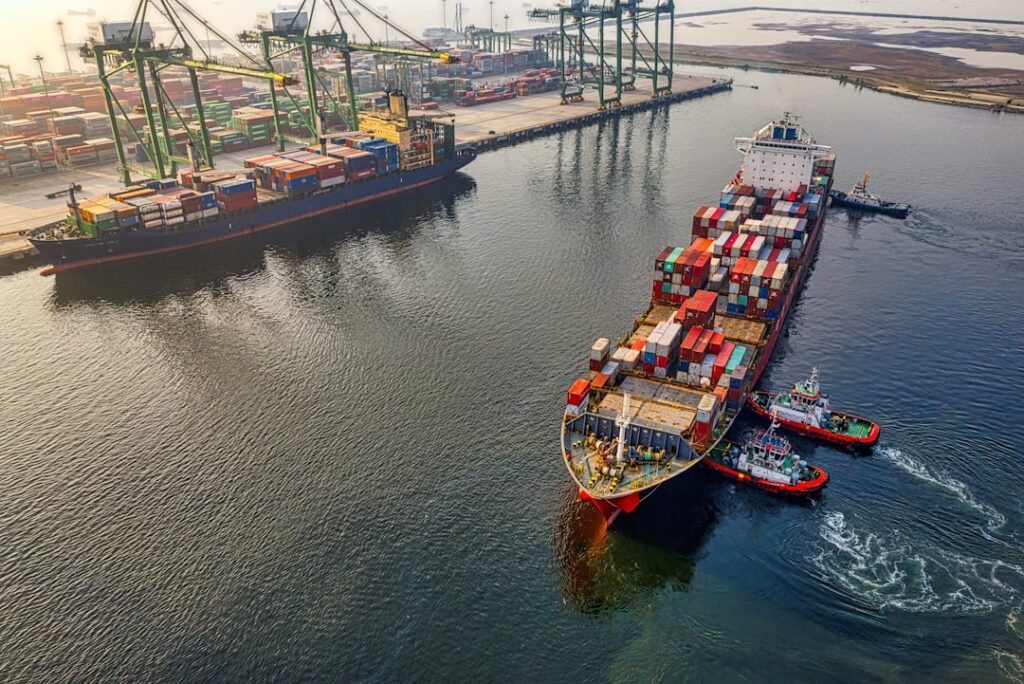 A cargo ship sails across the open ocean under a cloudy sky, representing international waters governed by the new High Seas Treaty.