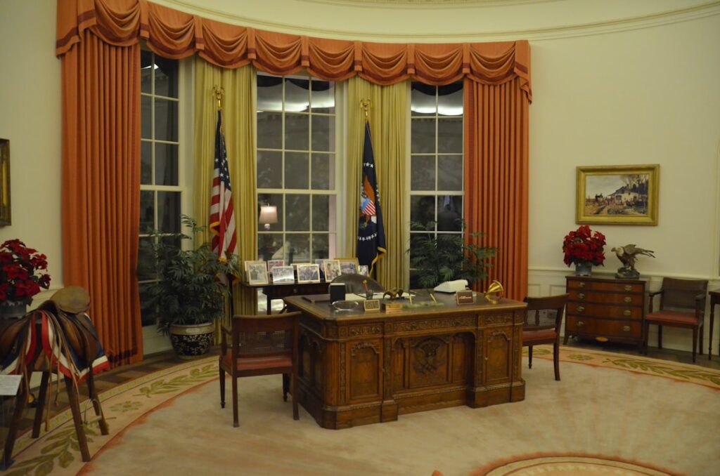 President Trump and Vice President Vance confront Ukrainian President Zelenskyy at a desk in the Oval Office during a tense meeting.
