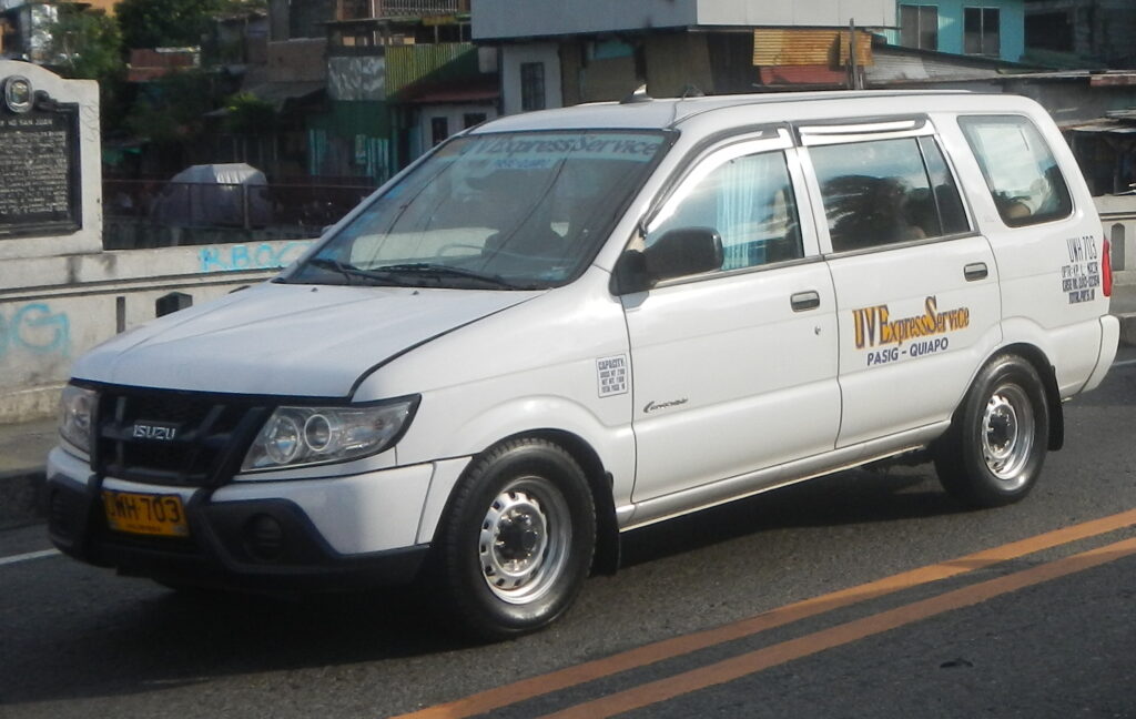 A damaged UV Express van rests at the scene of a collision with a truck on a road in Camalig, Albay, Philippines.