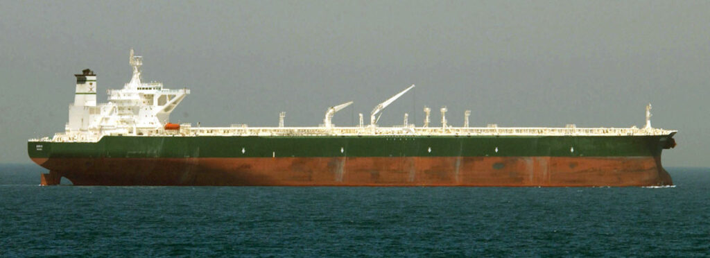 Two tankers on fire in the Bosporus waterway with rescue boats approaching to evacuate crew members.