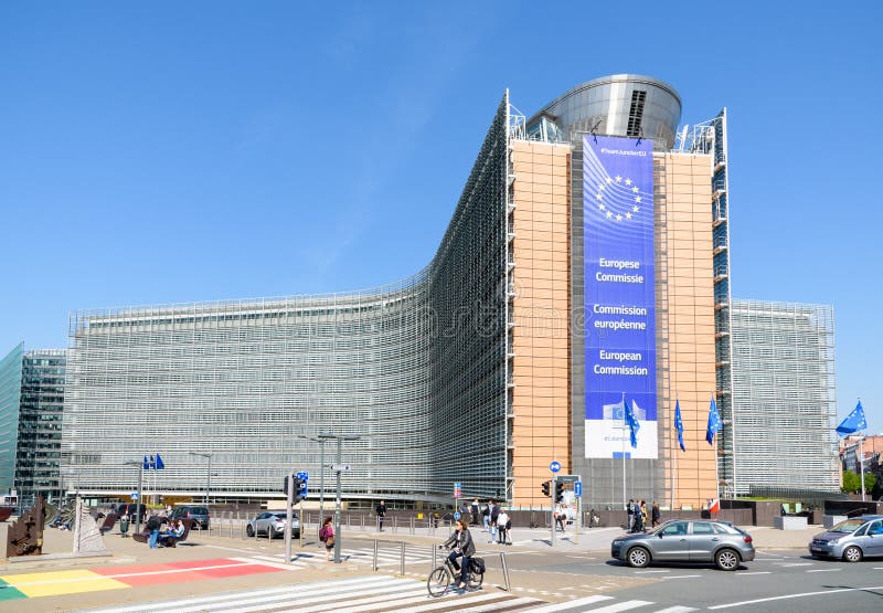 EU officials signing a document on Russian coal sanctions in a Brussels meeting room.