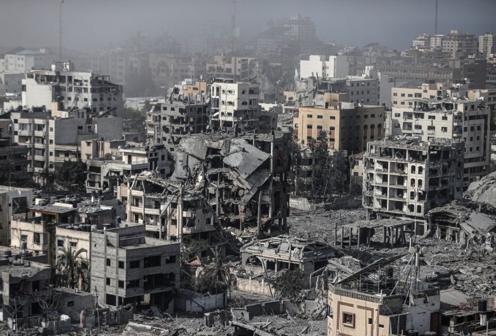 People gathered near a damaged building in Gaza, surveying the aftermath of an airstrike