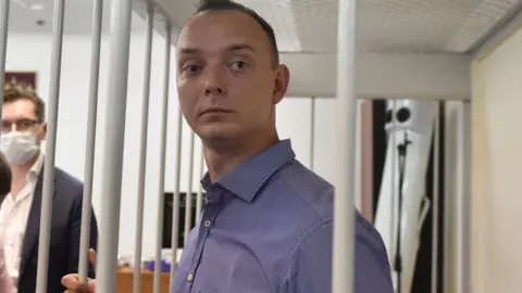 Ivan Safronov stands in a courtroom in Moscow during his trial on treason charges.