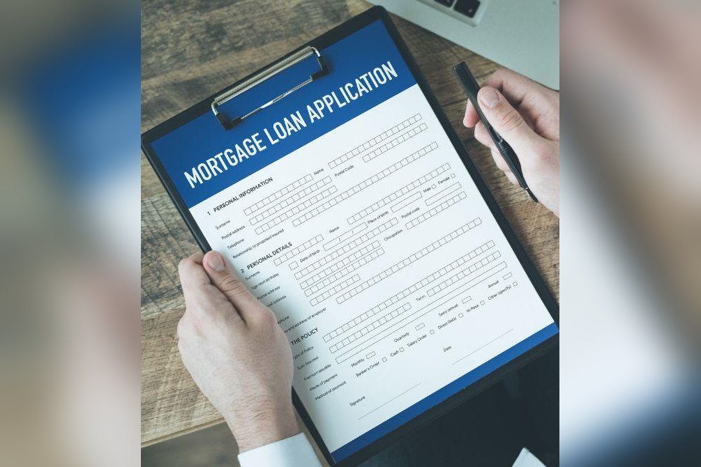 Person Holding A Mortgage Document